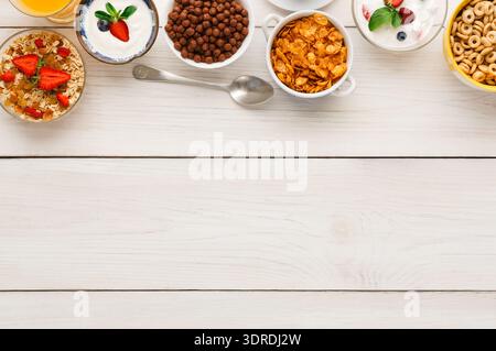 Breakfast Collection of Cereals and Fruits on a Wooden Table in a Kitchen Setting Stock Photo