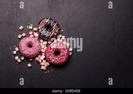 An eye-catching arrangement of colorful macarons on a dark background Stock Photo