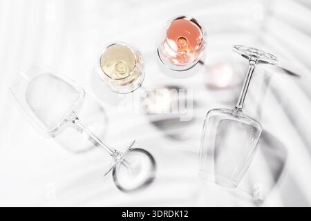 Two wine glasses filled with rose and white wine Stock Photo