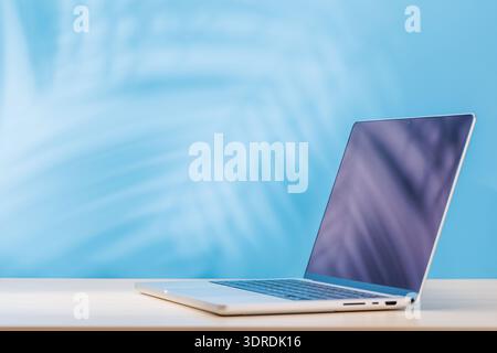 Laptop with a blank screen placed on a table Stock Photo