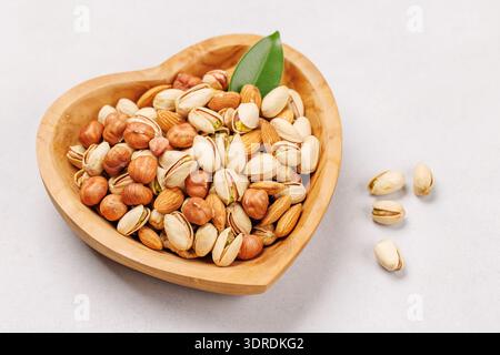 A vibrant mix of various nuts, including almonds, walnuts, hazelnuts, cashews, and pistachios Stock Photo