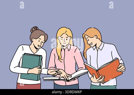 Smiling female colleagues discuss paperwork together Stock Photo