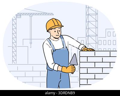 Male worker in uniform laying bricks Stock Photo