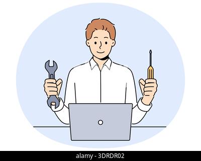 Man repairs laptop after breakdown and holds screwdriver and wrench, working as system administrator Stock Photo