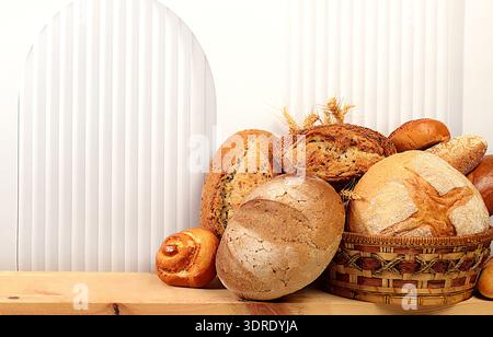 Freshly baked bakery products on the kitchen table. Whole grain homemade bread, various types of round sourdough bread with a cr Stock Photo