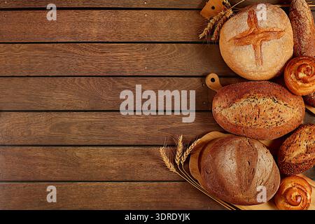 Freshly baked bakery products, whole grain homemade bread, different types of round sourdough bread with crispy crust, baguettes Stock Photo