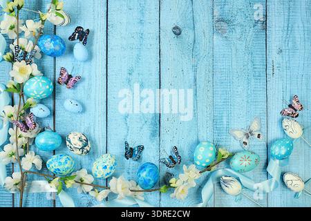 Happy Easter concept, Composition with decorated Easter eggs, butterflies and apple tree branches. banner or advertisement for s Stock Photo