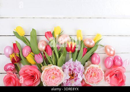 Happy Easter concept, spring card, composition with flowers and eggs on a gentle background. Festive minimal concept, place for Stock Photo