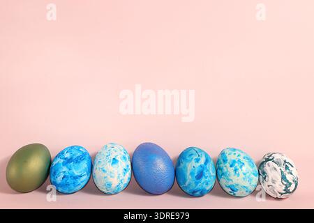 Decorated Easter eggs on a pastel background. Holiday minimal concept, postcard, Happy Easter concept, background. Creative pain Stock Photo