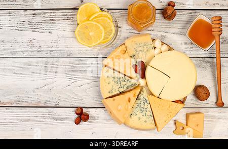 Blue cheese, gorgonzola, roquefort, parmesan, mozzarella, maasdam with honey and nuts, Assortment of different types of cheese, Stock Photo