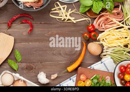 Pasta cooking ingredients and utensils on wooden table Stock Photo