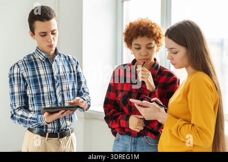 Teamwork brainstorm young professional team concept. Happy multiracial coworkers cooperating working together at office meeting. Stock Photo