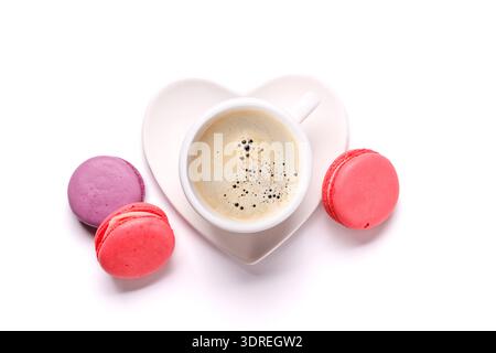 A simple and elegant arrangement of a coffee cup and colorful macarons isolated Stock Photo