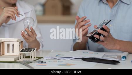 Two people are talking about a project on a table Stock Photo