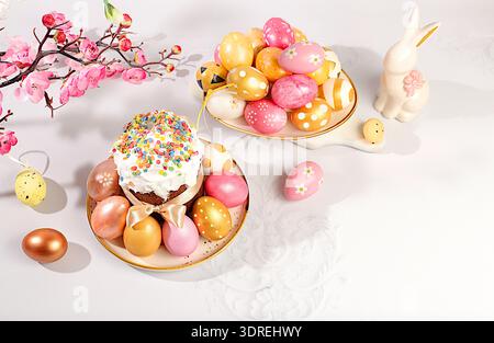 Abstract Easter composition with traditional Russian kulich with meringue and decorated painted eggs on elegant table with sprin Stock Photo