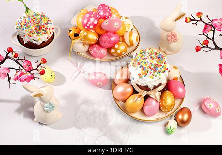 Abstract Easter composition with traditional Russian kulich with meringue and decorated painted eggs on elegant table with sprin Stock Photo