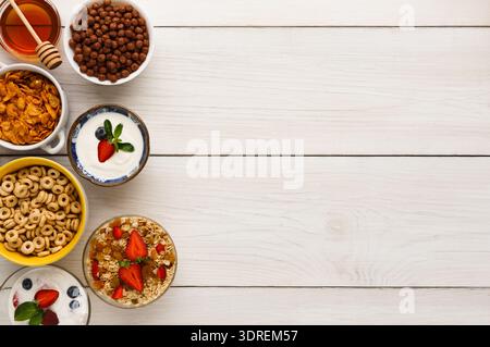 Various Breakfast Items Arranged in a Colorful Collection on a Wooden Table Surface Stock Photo