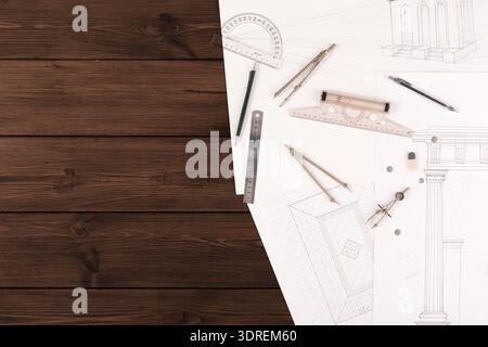 Collection of Drawing Tools and Architectural Sketches on a Workspace Stock Photo