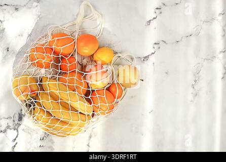 Dietary fruits in fabric packaging. Banner for store. Healthy natural products in eco bag to boost immunity, healthy lifestyle c Stock Photo