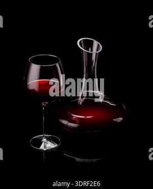 Elegant presentation of red wine in a glass and a decanter against a dark background Stock Photo
