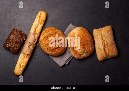 An assortment of freshly baked bread displayed on a table Stock Photo