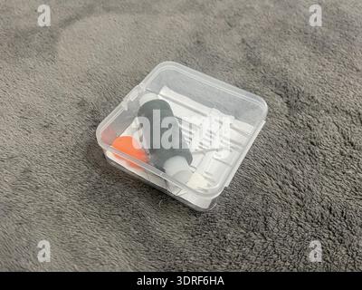 A tailor's sewing kit on a table. Needles, thread, and fabric for sewing. Stock Photo