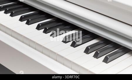 Black and white piano keys closeup with light gradient. Stock Photo