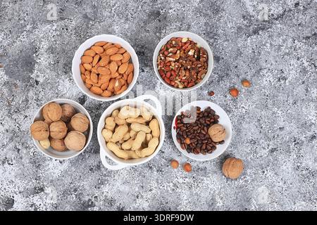 Assortment of different nuts, the concept of healthy natural food, almonds, pecans, pistachios, cashews, walnuts and pine nuts, Stock Photo