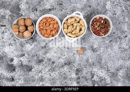 Assortment of different nuts, the concept of healthy natural food, almonds, pecans, pistachios, cashews, walnuts and pine nuts, Stock Photo