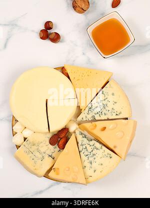Blue cheese, gorgonzola, roquefort, parmesan, mozzarella, maasdam with honey and nuts, Assortment of different types of cheese, Stock Photo