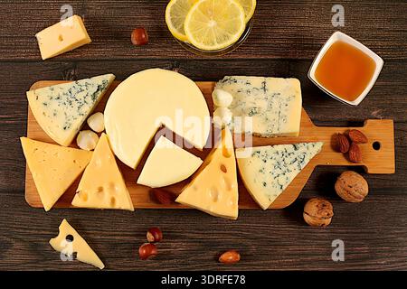 Blue cheese, gorgonzola, roquefort, parmesan, mozzarella, maasdam with honey and nuts, Assortment of different types of cheese, Stock Photo