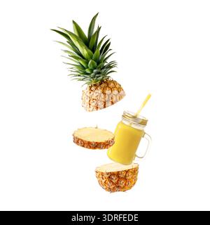 Fresh juicy tropical fruit pineapple  and smoothie glass jar flying isolated on white background. Sliced ananas pineapple and juice  falling. Stock Photo