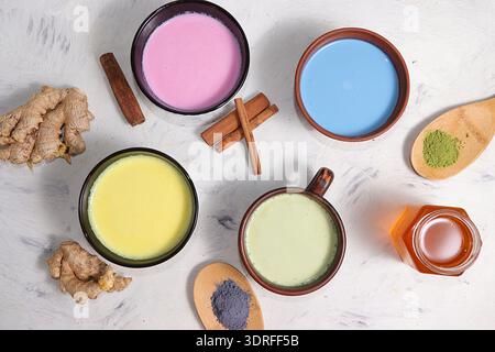 An assortment of colorful latte Japanese tea, matcha green, blue, pink moon milk, golden milk, ginger and cinnamon, top view. A Stock Photo