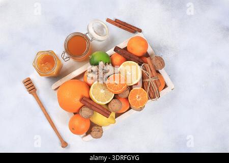 Healthy drink of golden turmeric latte with ginger root, cinnamon sticks, turmeric powder, a cup of milk and honey, spices for A Stock Photo
