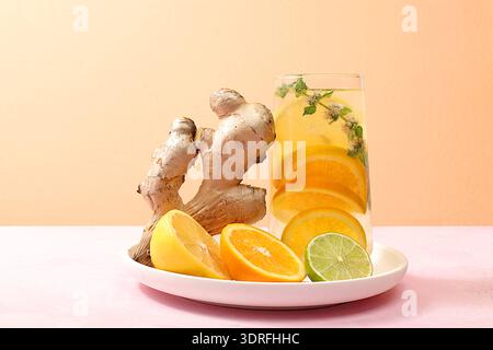 Detox drink with lemon, mint, lime and ginger on a light table, mojito or cocktail improves metabolism, promotes weight loss and Stock Photo