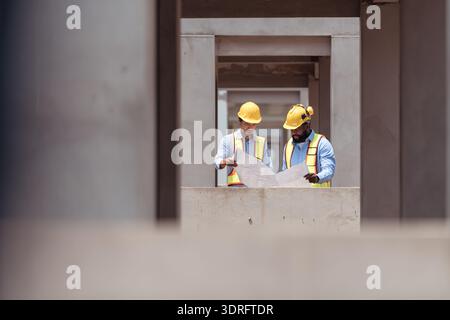 Architects and engineers work together to assess the residential home construction site's progress Stock Photo