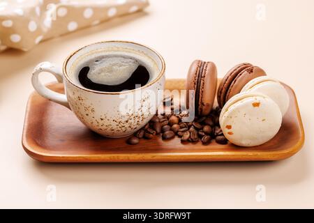 Coffee cup and macaroons on a beige background Stock Photo