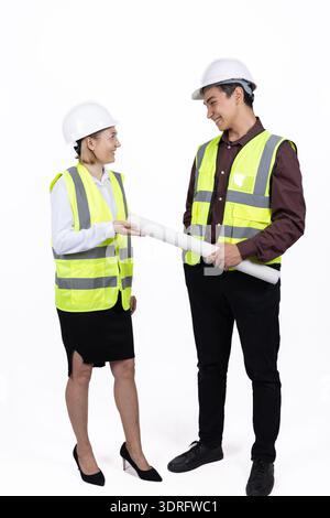 Two engineers discussing a project with blueprints Stock Photo