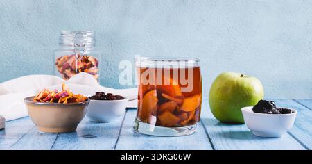 Traditional drink made from prunes, raisins and apples uzvar in a glass on the table web banner Stock Photo