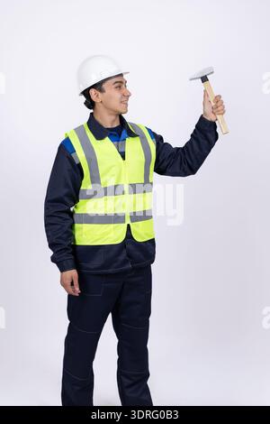 Builder measuring a wall with a metal level tool Stock Photo