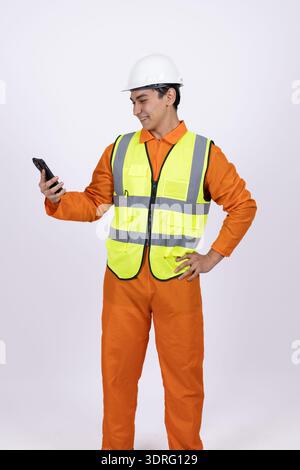 Worker in safety vest using a walkie talkie Stock Photo