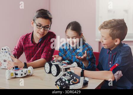 Kids Build and Learn About Robots During Education Activity in Classroom Stock Photo