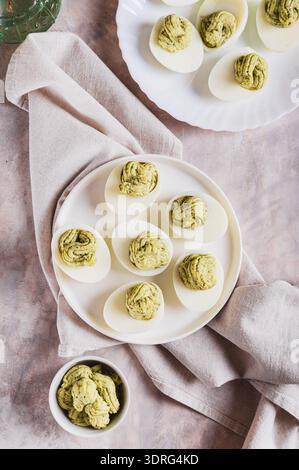 Avocado deviled eggs for appetizer on plate on table top and vertical view Stock Photo