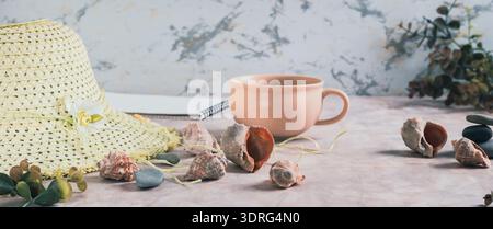 Travel background, hat, shells, stones and cup of coffee on table web banner Stock Photo