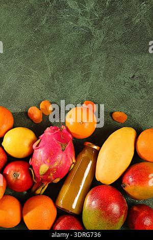 Banner with tropical exotic fruits and juice on concrete background, summer vacation and healthy lifestyle concept. Advertising Stock Photo