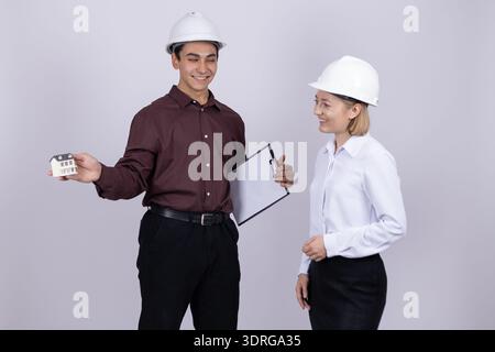 Engineers in safety gear discussing project details Stock Photo