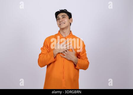 Happy worker holding his hand on his heart Stock Photo
