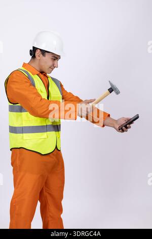 Construction worker using a hammer and a level Stock Photo