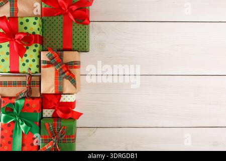 Collection of Colorful Gift Boxes Stacked on a Wooden Background for a Festive Occasion Stock Photo