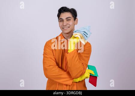 Cleaner in orange uniform holding various supplies Stock Photo